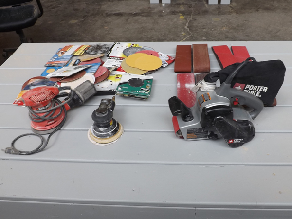 lot 24 image: Large Lot of Sanding Supplies w Porter Cable 3 x 21 Belt Sander etc.