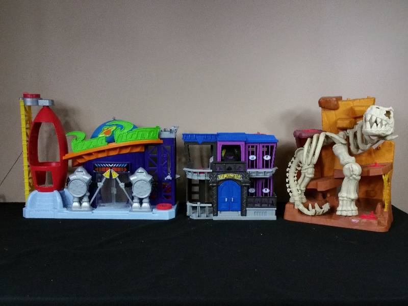 lot 78 image: Fisher Price Jurassic, Batman, and Toy Story Playsets