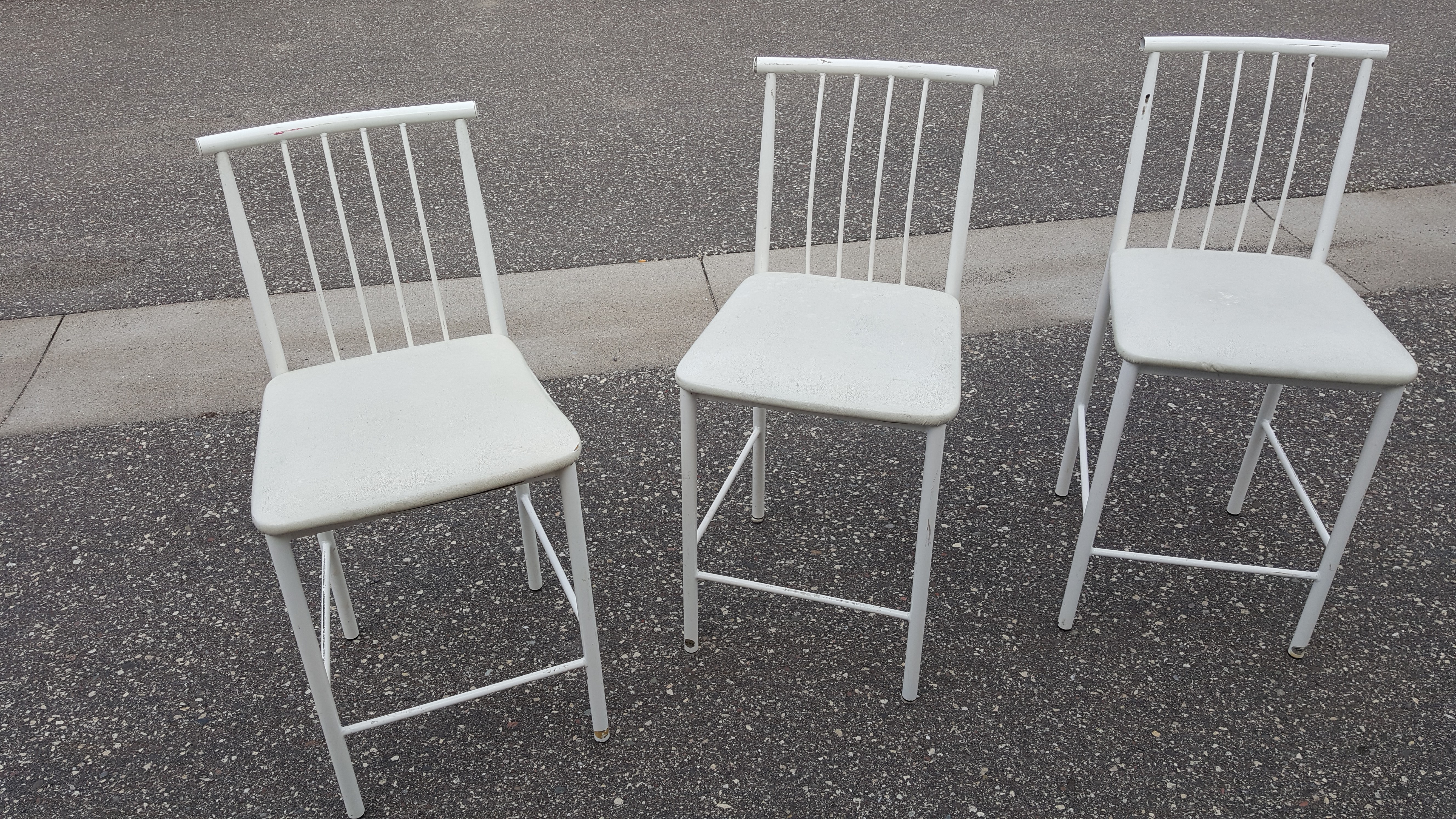 Three white bar chairs