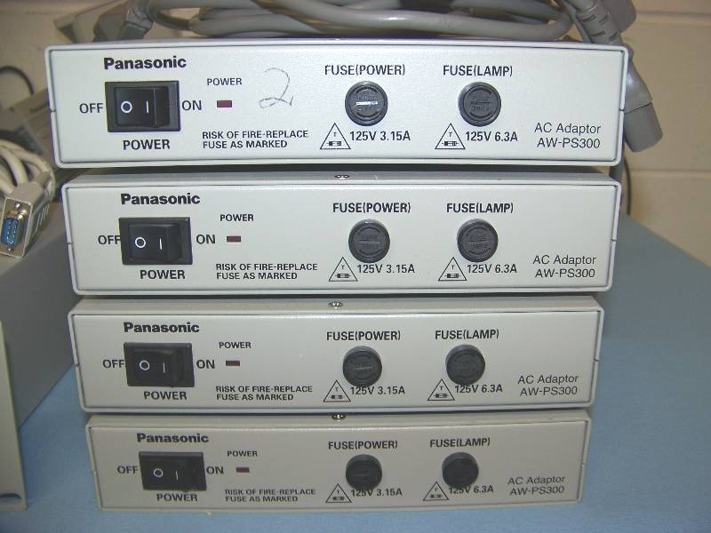 lot 36 image: Panasonic, (4) Cameras with Pan  Tilt Mounts  Heads, (4) AC Adaptors, (1) Multi-Port Hub and (1) Multi Hybrid Control Panel