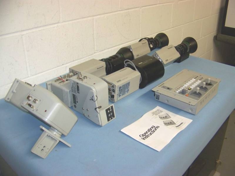 lot 38 image: (1) Panasonic, Multi Hybrid Control Panel, (4) Cameras and (2) Pan  Tilt Security Mounts  Heads
