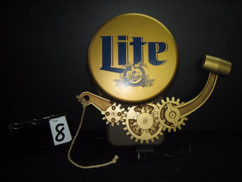 lot 8 image: Miller Lite steampunk tip bell, makes different sounds when rope is pulled gong, clapping, slot machine payout, ship bell and more. Great condition, you want this.