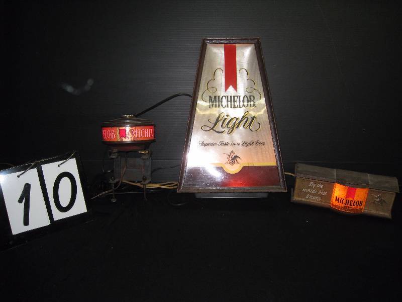 lot 10 image: Michelob lighted beer signs (3 items) cash register topper blinks red 5.5 diam, bottle lable 10w x 16 h x 4 d, rectangular cash register topper 10 w x 3.5 x 3.5
