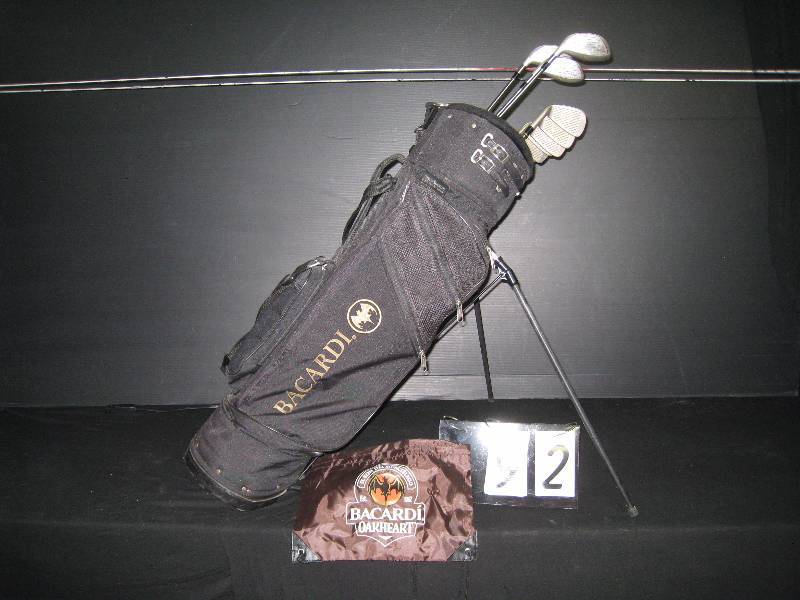 lot 92 image: Bacardi golf clubs and standup bag, with Bacardi logo accessory bag - may be Calloway clubs