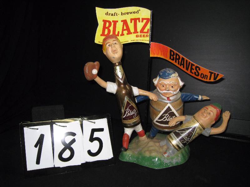 lot 185 image: Darft Brewed Blatz Brings you the Braves on TV baseball statue - heavy cast metal base, metal characters. Appears complete (with baseball and no missing hands)