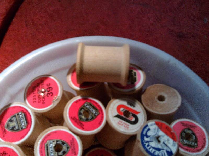 ICE CREAM PAIL OF WOODEN THREAD SPOOLS