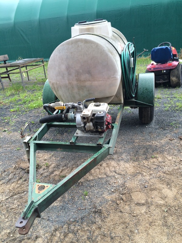 lot 1 image: 300 Gallon Water Tank  4hp Honda Includes tailer and has off road tires - No leaks and runs fine