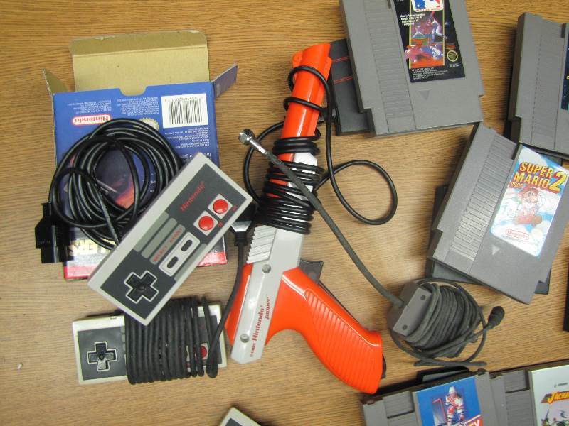 lot 74 image: Vintage Nintendo Games, controls & a gun