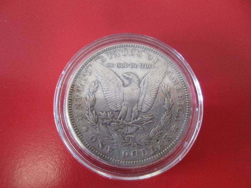1887-P Morgan Silver Dollar in protective capsule.  The capsule can be easily opened if the winning bidder wishes to transfer to a collection folder.