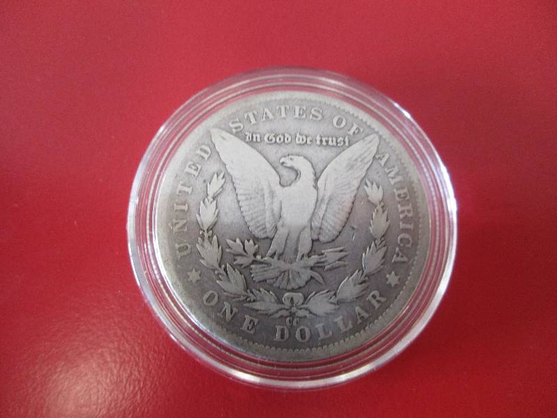 1890-CC Morgan Silver Dollar in protective capsule. The capsule can be easily opened if the winning bidder wishes to transfer to a collection folder.