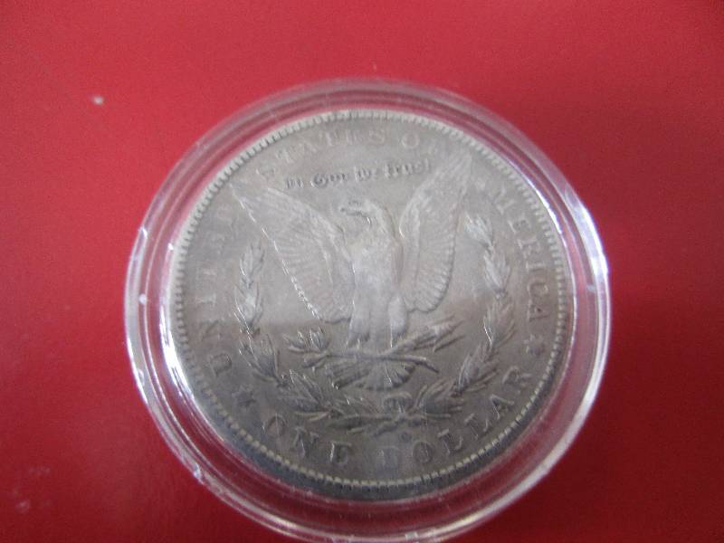 1901-O Morgan Silver Dollar in protective capsule. The capsule can be easily opened if the winning bidder wishes to transfer to a collection folder.