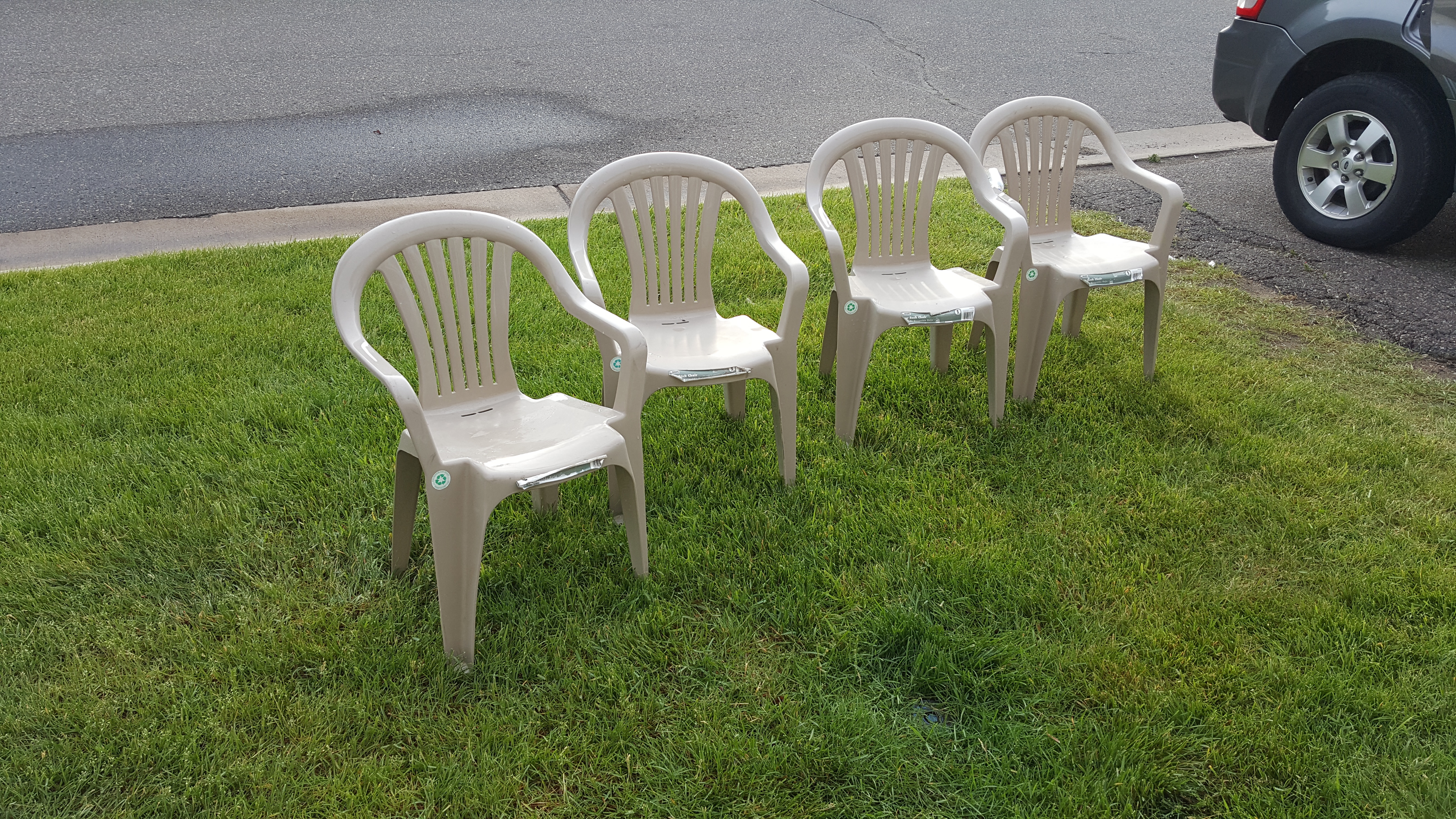 Four plastic lawn chairs