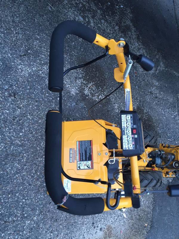 lot 78 image: Cub Cadet VT100 (18) 208cc Vertical Tine Dual Direction Rear Tine Tiller works however bail clutch is not original it has been adapted and cable needs adjustment and the belt cover is missing