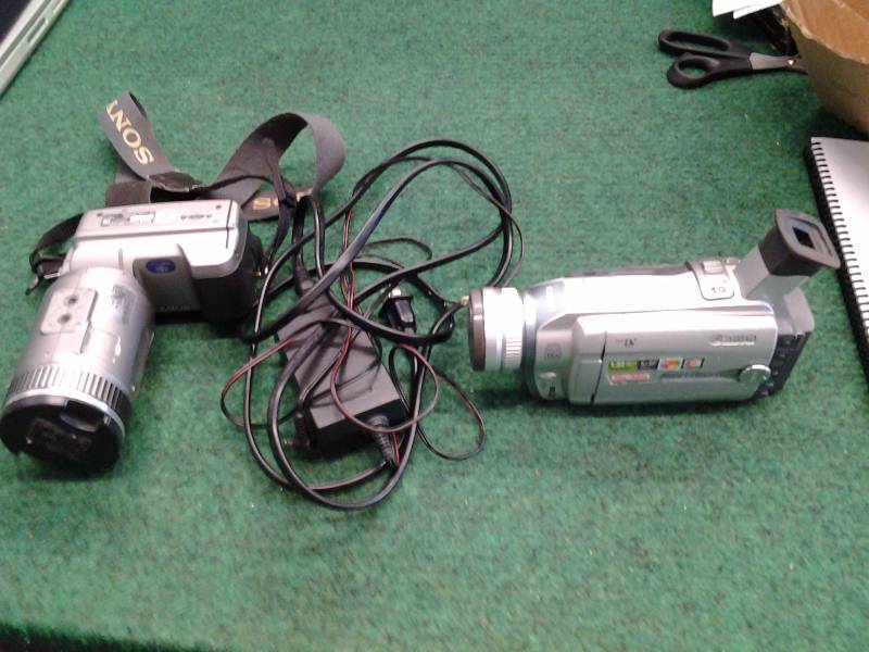lot 24 image: Canon Optura 20 Digital Video Camcorder With Charger & Power Cord, Sony Cyber Shot Camera With 10x Zoom Lens