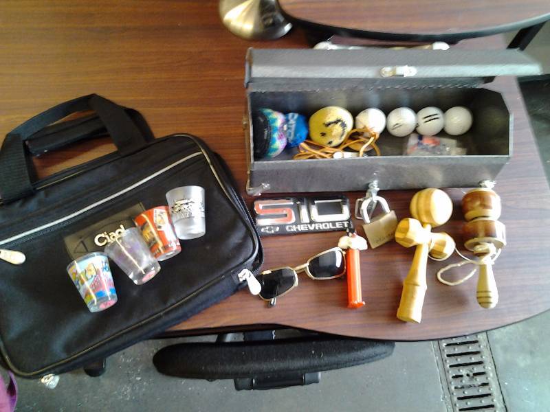 lot 31 image: Shotglasses, Hacky Sacks, Golf Balls, Wood Yo-Yos, Tool Box, Travel Bag