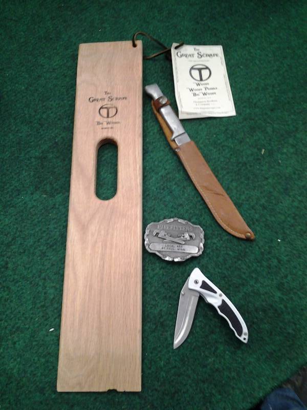lot 37 image: The Great Scrape BBQ Grill Scraper, Filet Knife With Sheath, Frost Cutlery Folding Knife, Pipe Fitters Union Belt Buckle