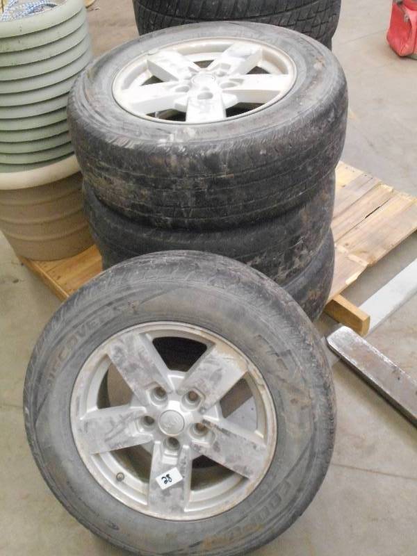 lot 28 image: (4) Jeep 5-Lug 17 Wheels With Coop...