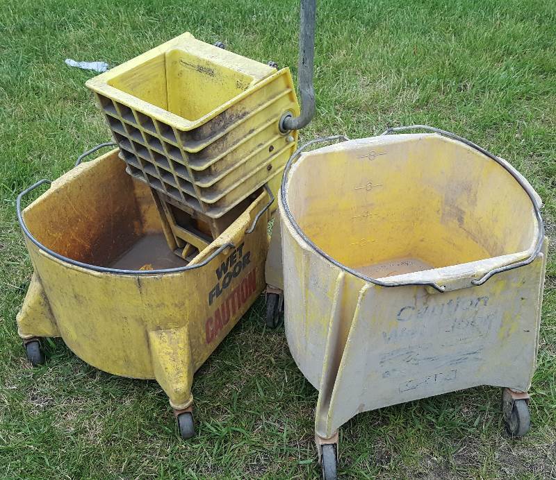 Two industrial mop buckets, one top ring