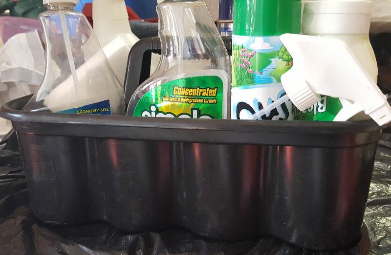 Rubbermaid Black caddy with used chemicals.