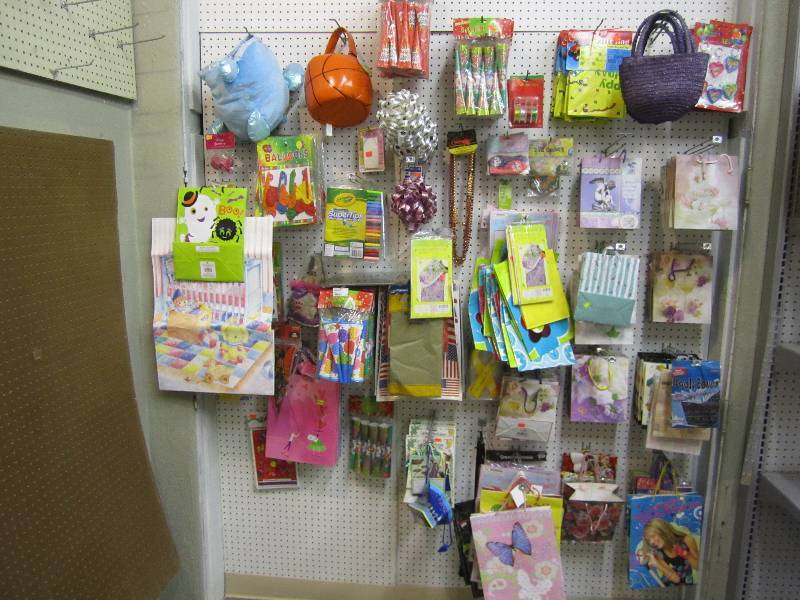 lot 107 image: Entire wall display of gift bags an...