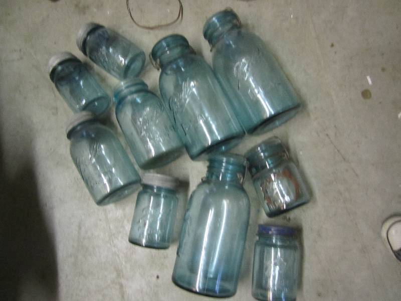 lot 35 image: Lot of blue mason jars- some with l...