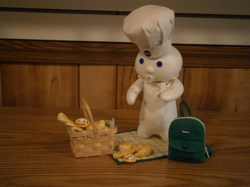 lot 33 image: Danbury Mint Picnic Surprise Porcelain Pillsbury Doughboy Figurine