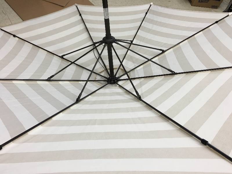 lot 126 image: umbrella with two tiki torches