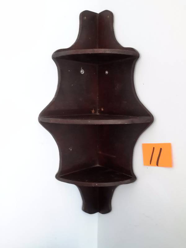 Corner display shelf.. Solid wood.. Not sure of type.. Stained dark