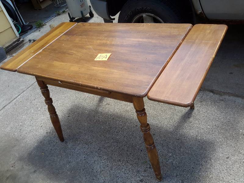 Vintage solid wood table.. Looks like Maple.. Slide under leafs.. Nice shape