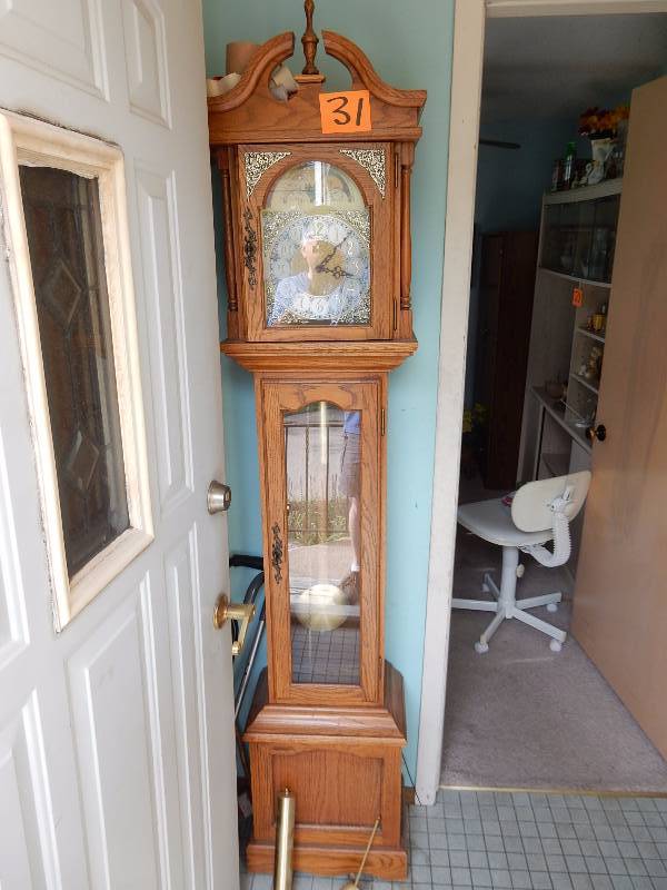 Grand Mother Clock.. Oak. Nice shape, but is not running. We think it just needs to have all the weights attached, but not sure.  Please inspect or buy knowing you can repair it.