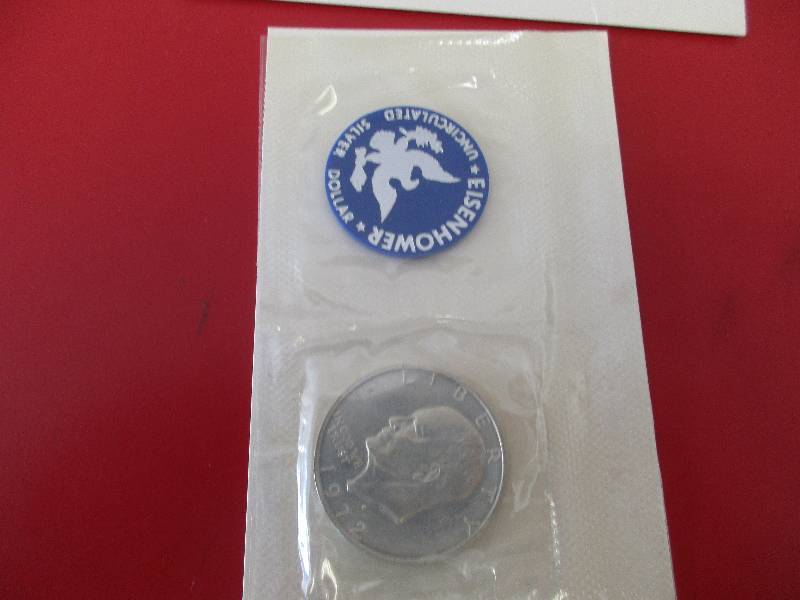 Lot #26  1972-S Eisenhower 40% Silver Dollar in original government packaging  Also known as the Blue Ike