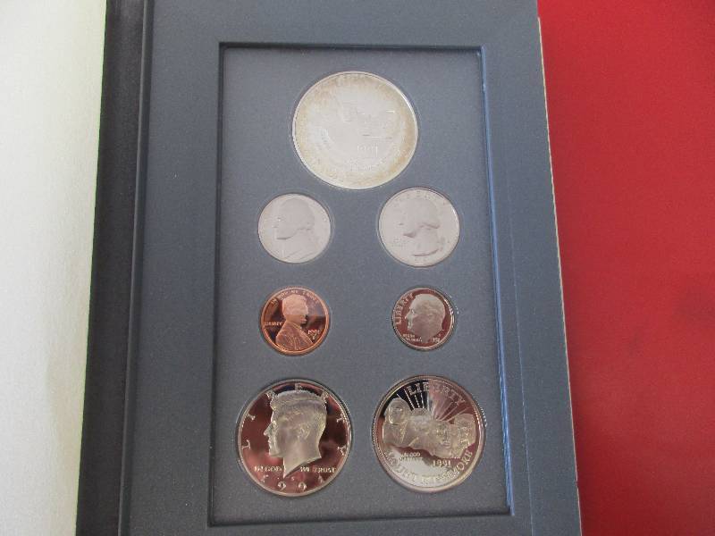 Lot #28  1991 US Mint Prestige Set with original Box and certificate of authenticity. Featuring the Mount Rushmore Anniversary Silver Dollar and Half Dollar as well as the Kennedy Half Dollar.