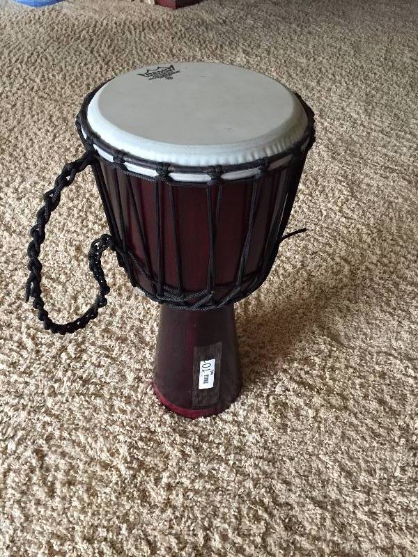 lot 101 image: WOW Large 24 Tall Remo Djembe Weatherking Coated Ambassador Hand Carved African Djembe Hand Drum, BOOMING BASS - Excellent - Rope Included - Retails New About $450