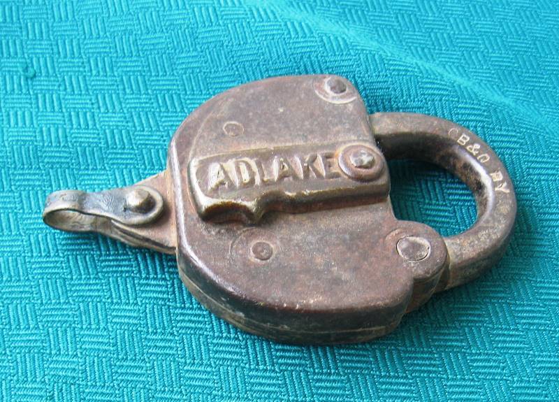 lot 013 image: Vintage Adlake B&O Railway Railroad Padlock & Key, Spike & Charm