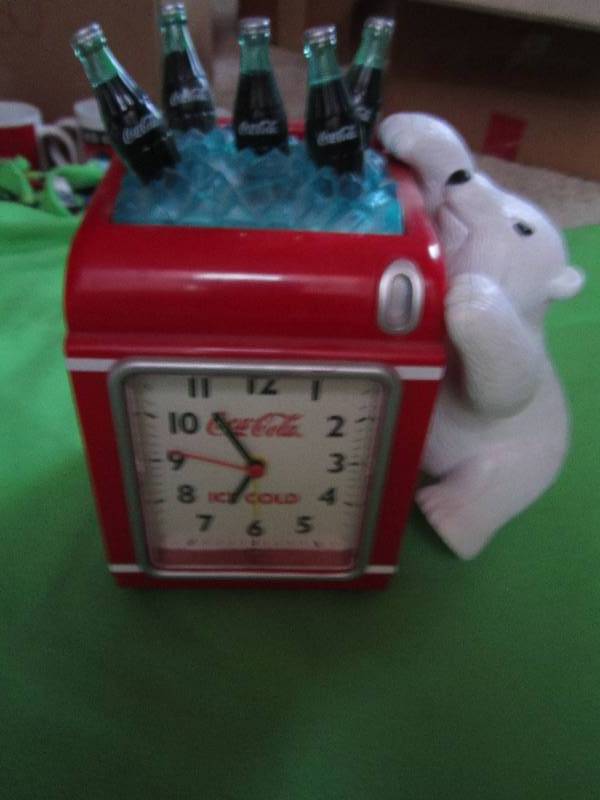lot 106 image: Coca-cola clock and piggy bank in o...