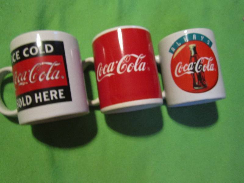 lot 109 image: Set of 3 Coca-cola mugs...