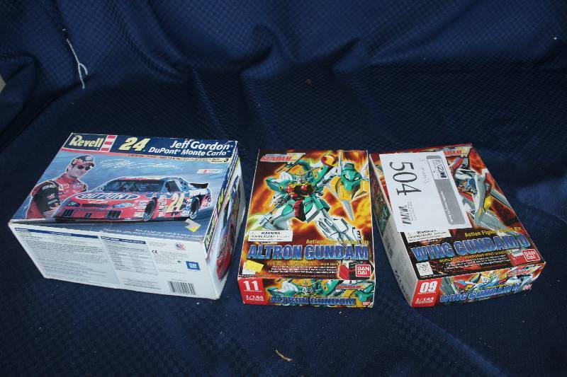 lot 504 image: Lot of (3) Scale Models Including 1) Revell Jeff Gordon 24 Dupont Monte Carlo AND 1) Altron Gundam AND 1) Wing Gundamo