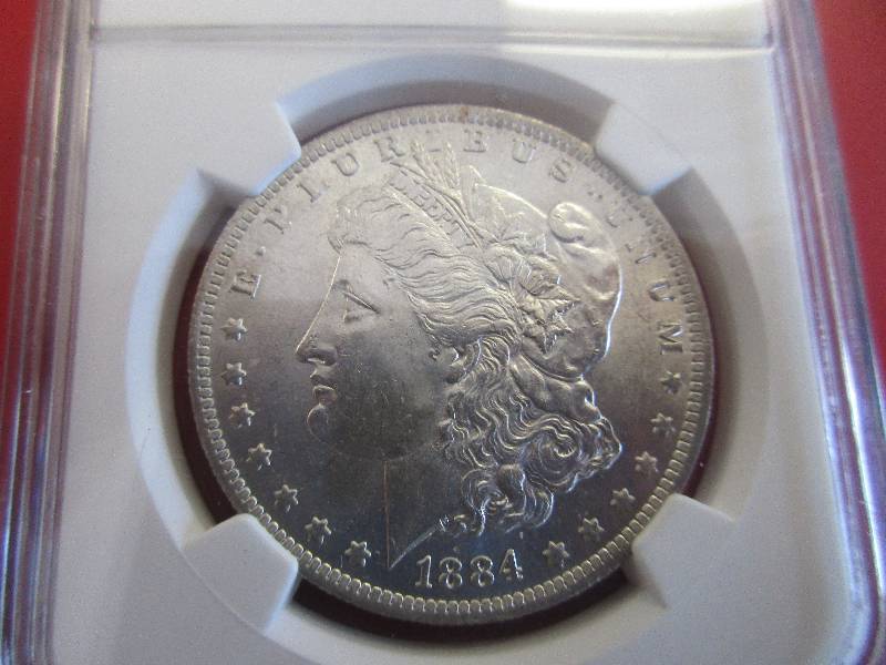 Lot #5 - 1884-O (New Orleans Mint) NGC Certified Morgan Silver Dollar in Mint State 61 grade. Beautiful 90% Silver coin with cartwheel effect and mint luster.