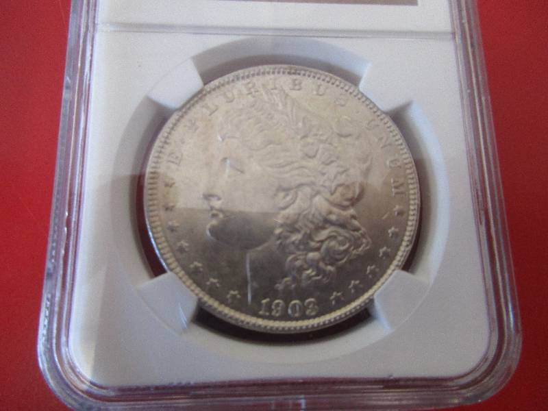 Lot #6 - Nice 1903-P NGC Certified Morgan Silver Dollar in Mint State 62 condition. This is a mint state coin which is harder to find in this higher quality. Nice cartwheel effect and luster to the coin.