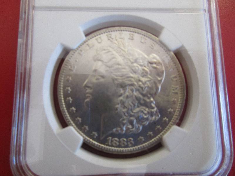 Lot #12  1883-O NGC Certified Morgan Silver Dollar in Mint State 62 condition Nice cartwheel effect and luster to the coin.