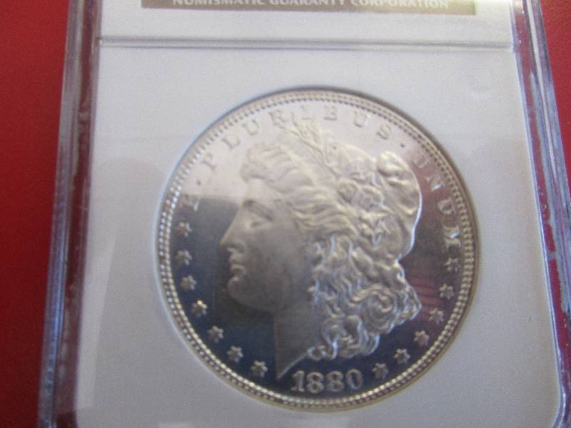 Lot #14 - 1880-S Morgan Silver Dollar NGC Certified in Mint State 62 Condition. Beautiful 90% Silver coin with cartwheel effect and mint luster.