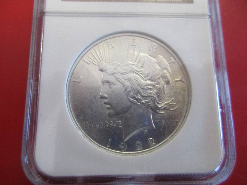 Lot #26 - 1922-P Silver Peace Dollar NGC Certified in Mint State 62 Condition. 90% silver coin composition in high quality condition.