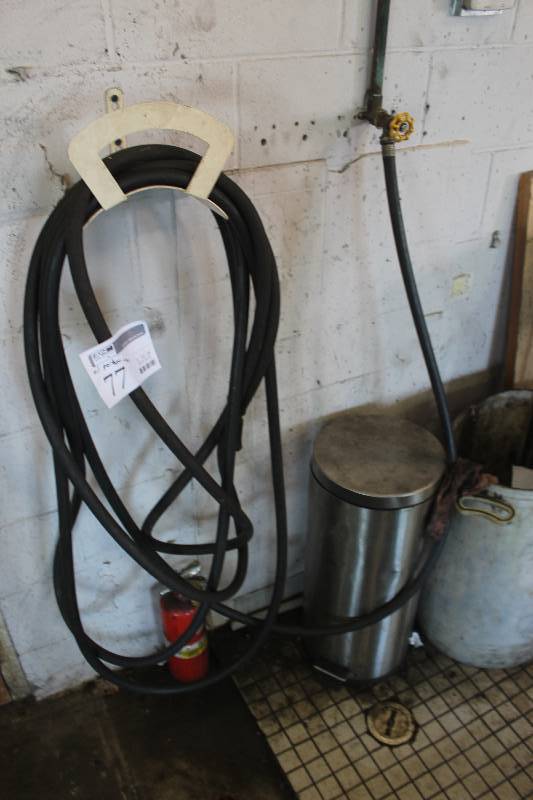 lot 77 image: Garden Hose w Garbage Can