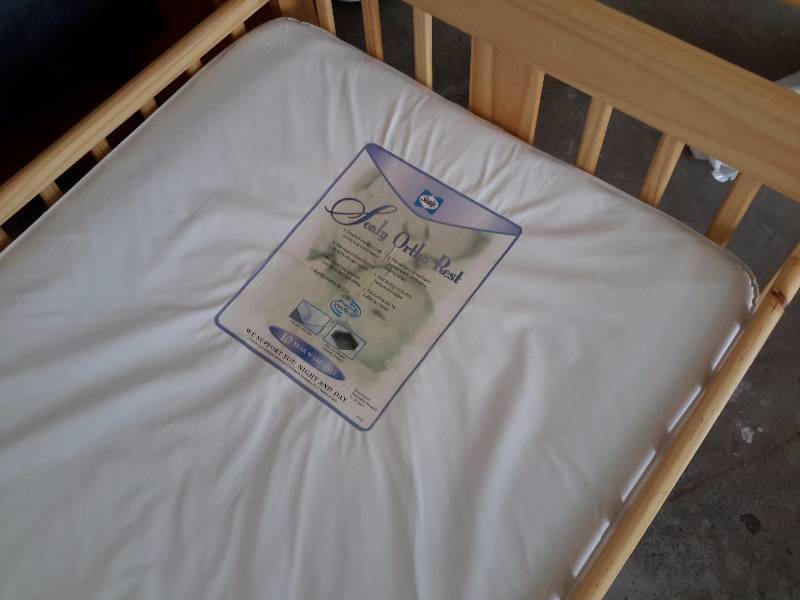 Child size maple bed with plastic covered mattress.. VERY NICE Shape