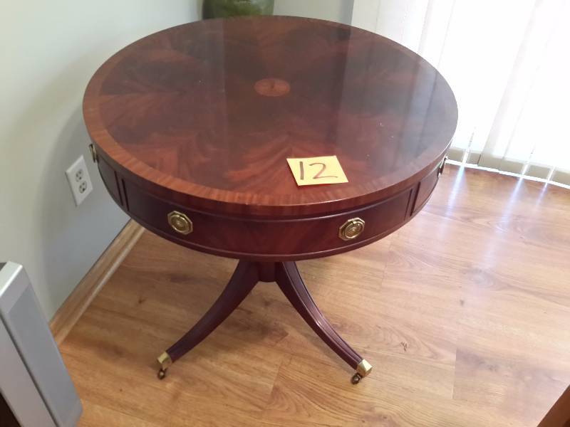 Hickory Chair Company, Round occasional table.  Side drawer.. Brass leg covers on casters.  Dim 30in diameter x 27 in h.