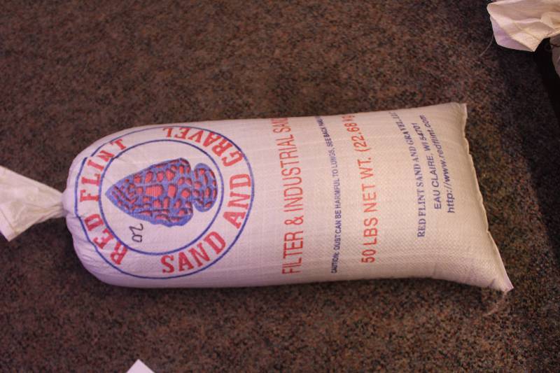 lot 271 image: Bag Lot of 50lbs Red Flint Sand & Gravel Filter & Industrial Sand