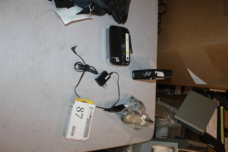 lot 87 image: Lot of (4) Electronics Including 1) Korg MA-1 Metronome AND 1) Microphone AND 1) Netgear Wireless-N 150 Router AND 1) Motorola Surfboard SB6121