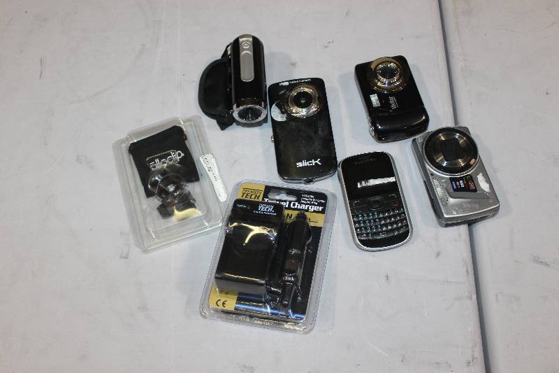 lot 299 image: Lot of (7) Electronics Including 1) Vivitar Digital Camera AND 1) 14 Megapixel Camera AND 1) Alcatel Phone AND 1) Canon PT-33 Travel Charger AND 1) Olloclip AND 1) Jazz DV140 Video Recorder AND 1) Slick Digital Video Camera