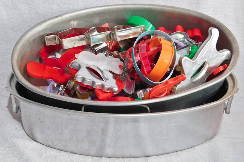 lot 55 image: large metal roaster pan filled with cookie cutters