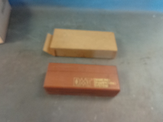 lot 307 image: Harmonica and Wet stone